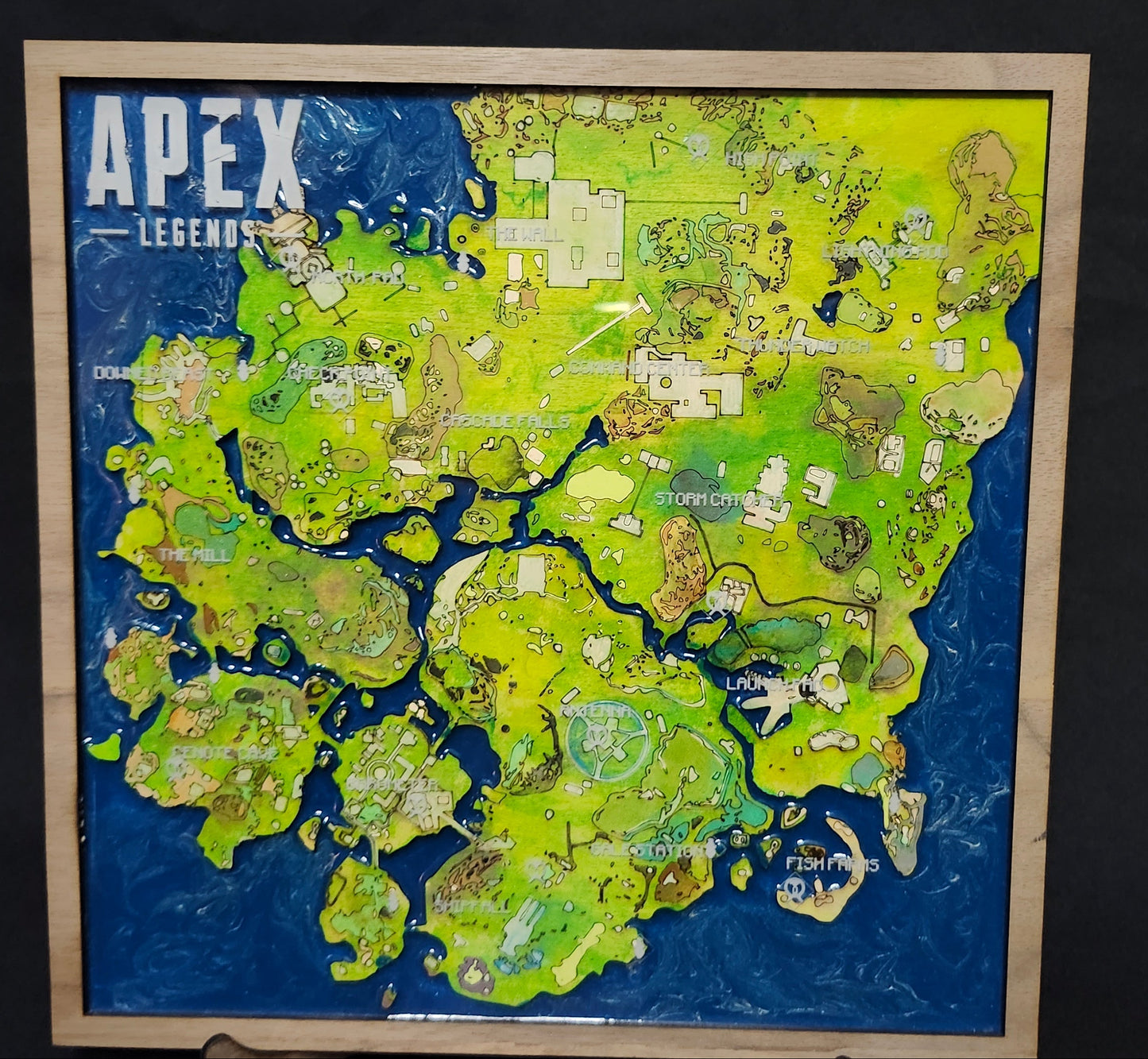 Handmade wooden map of Apex Legends game, featuring various colors representing different terrains and landmarks from the game.